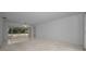 Spacious living area featuring a sliding glass door to the lanai and neutral walls at 2700 Westchester N Dr, Clearwater, FL 33761