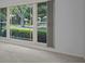 Large window with an unobstructed view of the well-manicured front yard and neighborhood at 2700 Westchester N Dr, Clearwater, FL 33761