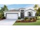 Charming single-story home with a two-car garage, stone accents, and well-maintained landscaping at 3320 Amber Waves Dr, Plant City, FL 33565