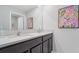 Bathroom featuring a double sink vanity with dark cabinets and marble countertop, mirror, and modern faucet at 3332 Ivy Hollow Dr, Plant City, FL 33565