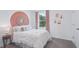 Cozy bedroom with a comfortable bed, artistic wall decor, and a large window for natural light at 3332 Ivy Hollow Dr, Plant City, FL 33565