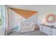 Stylish Bedroom with white crib, creative wall decor, and a modern dresser, bathed in soft natural light at 3338 Ivy Hollow Dr, Plant City, FL 33565