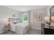 Inviting bedroom with a bed, dresser, and a large window, decorated with plants and calming colors at 3338 Ivy Hollow Dr, Plant City, FL 33565