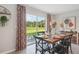 Inviting dining area with a wooden table, seating for six, and sliding glass doors to the backyard at 3338 Ivy Hollow Dr, Plant City, FL 33565