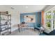 Stylish home office with blue accent wall, modern desk, comfortable seating, and bright natural light at 3338 Ivy Hollow Dr, Plant City, FL 33565