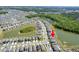 An aerial view of a well-planned community with homes, ponds, and green areas, backing to mature trees at 35853 Buttonweed Trl, Zephyrhills, FL 33541