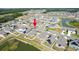 An aerial view of a well-planned community, with the home located on a corner lot backing to a pond at 35853 Buttonweed Trl, Zephyrhills, FL 33541