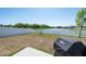 Beautiful backyard with a tranquil lake view and white picket fence at 35853 Buttonweed Trl, Zephyrhills, FL 33541