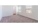 Bright, carpeted bedroom with two windows, ideal for creating a personalized and comfortable living space at 35853 Buttonweed Trl, Zephyrhills, FL 33541