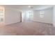 Spacious carpeted bedroom with natural light, ideal for creating a relaxing and comfortable living space at 35853 Buttonweed Trl, Zephyrhills, FL 33541