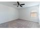 Bright bedroom with a ceiling fan and large window, offering a comfortable and inviting space at 35853 Buttonweed Trl, Zephyrhills, FL 33541