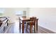 Bright dining area features wood-look floors and an adjacent view of the backyard at 35853 Buttonweed Trl, Zephyrhills, FL 33541
