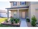 Inviting front porch with a decorative garden, enhancing the home's curb appeal at 35853 Buttonweed Trl, Zephyrhills, FL 33541