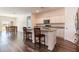 Open floor plan kitchen with island seating and modern appliances, creating a social space at 35853 Buttonweed Trl, Zephyrhills, FL 33541
