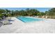 Community pool with lounge chairs and plenty of space to relax with friends and Gathering at 35853 Buttonweed Trl, Zephyrhills, FL 33541