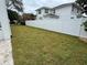 Spacious backyard featuring a lush lawn and a long white fence, offering privacy and space at 3910 W San Carlos St, Tampa, FL 33629