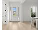 Bright foyer with hardwood floors, white trim, and a view of the home across the street at 3910 W San Carlos St, Tampa, FL 33629