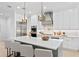 Spacious kitchen featuring white cabinets, stainless steel appliances, and a large island with seating at 3910 W San Carlos St, Tampa, FL 33629