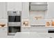 Close-up of kitchen with stainless steel appliances and stylish tile backsplash at 3910 W San Carlos St, Tampa, FL 33629