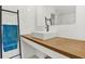 Modern bathroom featuring subway tile, wood countertop, and a sleek, square sink basin at 404 Danube Ave, Tampa, FL 33606