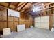 Spacious garage with overhead door, concrete floor, and exposed wooden beams and ceiling at 404 Danube Ave, Tampa, FL 33606