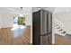 Bright living space with hardwood floors, stainless steel refrigerator, and sliding glass doors to a private patio at 404 Danube Ave, Tampa, FL 33606