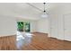 Well-lit living room featuring hardwood floors, white walls, and sliding glass doors to outdoor view at 404 Danube Ave, Tampa, FL 33606