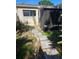 Backyard featuring a stone paver pathway and a screened enclosure at 414 Danube Ave, Tampa, FL 33606