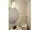 Bathroom with sink, toilet, and a round mirror, providing a clean and functional space at 414 Danube Ave, Tampa, FL 33606