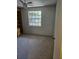 The bedroom features carpet, a ceiling fan and a window, creating a comfortable and relaxing atmosphere at 414 Danube Ave, Tampa, FL 33606