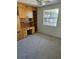 Bedroom features neutral carpet, a ceiling fan, a window and built-in shelves and cabinets, providing storage at 414 Danube Ave, Tampa, FL 33606