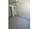 The comfortable bedroom features neutral carpet, a ceiling fan, and a door offering an inviting space at 414 Danube Ave, Tampa, FL 33606