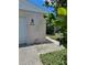 Home exterior with brick facade, house number 414, decorative rocks, and manicured greenery at 414 Danube Ave, Tampa, FL 33606
