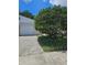 The exterior features a garage with a well-maintained lawn and vibrant green tree enhancing the property's curb appeal at 414 Danube Ave, Tampa, FL 33606
