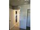 Hallway featuring a hardwood floor and leading to a carpeted room, offering a transition between spaces at 414 Danube Ave, Tampa, FL 33606