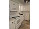 Contemporary kitchen with white cabinets, stainless steel appliances, and a sleek black faucet at 414 Danube Ave, Tampa, FL 33606