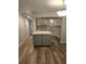 Modern kitchen boasts an island, updated lighting, and sleek wood floors for a stylish, functional space at 414 Danube Ave, Tampa, FL 33606