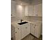 This modern kitchen features white cabinets, sleek countertops, and a stylish black faucet at 414 Danube Ave, Tampa, FL 33606