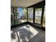 A screened in lanai featuring a door with a view of landscaping and a white fence at 414 Danube Ave, Tampa, FL 33606