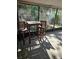 A screened in lanai with a high top table and chairs and landscaping views at 414 Danube Ave, Tampa, FL 33606