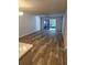 An open-concept living room with wood floors and a view of the screened porch at 414 Danube Ave, Tampa, FL 33606