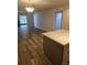 Open-concept living room with wood floors and sliding glass doors to a screened porch at 414 Danube Ave, Tampa, FL 33606