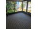 Enclosed sunroom with screen windows and access to the lush backyard at 414 Danube Ave, Tampa, FL 33606