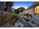 Landscaped backyard with a winding gravel path and lush greenery leading to the home at 420 48Th N St, St Petersburg, FL 33713