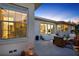 Backyard patio area at dusk featuring chairs and a dining set with sliding glass doors at 420 48Th N St, St Petersburg, FL 33713