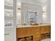 Bathroom featuring wood cabinets, marble countertops, and ornate lighting, blending luxury with functionality at 420 48Th N St, St Petersburg, FL 33713