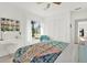 Bright bedroom featuring a patterned quilt, white furniture, closet, and sun-filled window at 420 48Th N St, St Petersburg, FL 33713