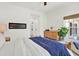 Bedroom with a linear fireplace, wood accents, light wood floors, and a leafy plant for a natural touch at 420 48Th N St, St Petersburg, FL 33713