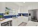 The kitchen is well-lit, and features blue tiled backsplash and stainless steel appliances at 420 48Th N St, St Petersburg, FL 33713