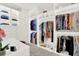 Spacious walk-in closet with custom shelving, hanging rods, and a desk area for optimal organization at 420 48Th N St, St Petersburg, FL 33713